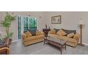 Living room with comfortable sofa and access to a balcony at 514 Lucaya Loop # 514, Davenport, FL 33897