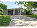 Mid-century modern home with a brick driveway and lush landscaping at 2148 Chippewa Trl, Maitland, FL 32751