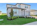 Two-story house with gray siding, brick driveway, and landscaping at 2462 Leeds St, Haines City, FL 33844