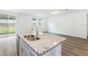 Kitchen with granite countertops and island at 2342 White Tail St, Davenport, FL 33837