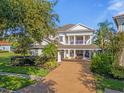 Two story home with covered porch and landscaping at 7481 Gathering Loop, Reunion, FL 34747