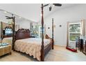 Main bedroom with four-poster bed and wood floors at 2713 Chatham Cir, Kissimmee, FL 34746