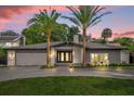 Stunning ranch home with circular driveway and palm trees at 238 E Lakeshore Dr, Clermont, FL 34711