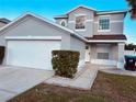 Two-story house with a double garage and well-manicured landscaping at 1347 Heather Lake Dr, Orlando, FL 32824