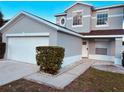 Two-story house with a double garage and well-manicured landscaping at 1347 Heather Lake Dr, Orlando, FL 32824