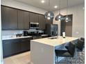 Modern kitchen with island, stainless steel appliances at 7740 Sandy Ridge Dr # 135, Kissimmee, FL 34747