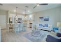 Open-concept kitchen and living area with modern appliances and furniture at 2112 Broome St, Kissimmee, FL 34743