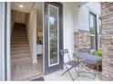 Townhouse entry with small patio, stairs, and view into the home at 2112 Broome St, Kissimmee, FL 34743
