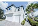 Modern two-story home with two-car garage and balcony at 1561 Corolla Ct, Reunion, FL 34747