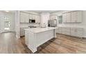 Modern kitchen with light gray cabinets and island at 14663 Englert Aly, Orlando, FL 32827