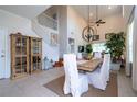 Spacious dining area with a wooden table, white chairs, and a view of the staircase at 6316 Miramonte Dr # 106, Orlando, FL 32835