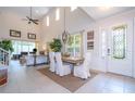 Bright dining room features a large wooden table with white chairs and a high ceiling at 6316 Miramonte Dr # 106, Orlando, FL 32835