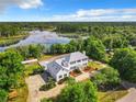 Two story house on a large lot with a lake in the background at 226 Mitnik Dr, Deltona, FL 32738