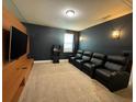 Home theater with leather recliners and large TV at 420 Lasso Dr, Kissimmee, FL 34747