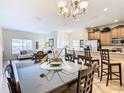 Open concept dining area with kitchen and living room views at 8967 California Palm Rd, Kissimmee, FL 34747