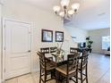 Dining area with a square glass table and six chairs at 8967 California Palm Rd, Kissimmee, FL 34747