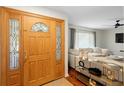 Bright entryway with hardwood floors, a wood door, and access to the living room at 115 Marcy Blvd, Longwood, FL 32750