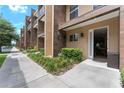 Modern townhome exterior with a landscaped walkway and open door at 3175 Brasilia Ave, Kissimmee, FL 34747
