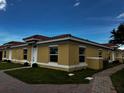 Exterior view of new yellow home with red tile roof at 1646 Cumin Dr, Poinciana, FL 34759