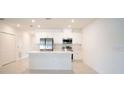 Modern kitchen with white cabinets and island at 1648 Andover Ridge Dr, Deland, FL 32720