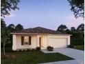 New construction home with a two-car garage and lawn at 1648 Andover Ridge Dr, Deland, FL 32720