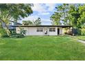 Single story home with a large front yard and driveway at 2140 Ridge Dr, Winter Park, FL 32792