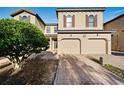 Two story tan townhome with double garage at 8091 Brooksville Dr, Davenport, FL 33896
