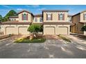 Tan townhome with double garage and curb appeal at 8091 Brooksville Dr, Davenport, FL 33896