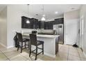 Modern kitchen with dark cabinetry and granite counters at 1209 Seburn Rd, Apopka, FL 32703