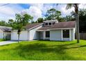 Single story home with attached garage and manicured lawn at 709 Del Rio Way, Kissimmee, FL 34758