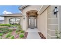 Inviting exterior with a covered entryway and well-manicured landscaping at 4070 Island Lakes Dr, Winter Haven, FL 33881