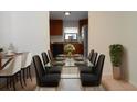 Bright dining room with a glass table and kitchen view at 1050 Abell Cir, Oviedo, FL 32765