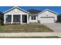 Craftsman style home with front porch and two car garage at 3287 Roseville Dr, Apopka, FL 32712