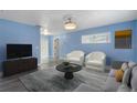 Living room with light blue walls and gray floors at 926 Everett St, Lake Alfred, FL 33850