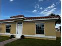 New yellow home with red tile roof, landscaping and brick walkway at 1648 Cumin Dr, Kissimmee, FL 34759