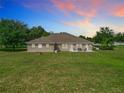 Rear view of the house with a large backyard at 24341 Milford Dr, Eustis, FL 32736