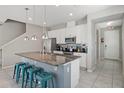 Modern kitchen featuring granite countertops and white cabinetry at 5116 Killarney Way, Kissimmee, FL 34746