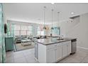 Open concept kitchen with granite island and stainless steel appliances at 5116 Killarney Way, Kissimmee, FL 34746