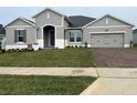 Two-story house with gray siding, brick driveway, and landscaping at 3279 Roseville Dr, Apopka, FL 32712