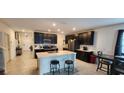 Modern kitchen with dark cabinets, stainless steel appliances, and island at 196 Taft Dr, Davenport, FL 33837