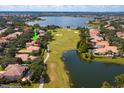 Aerial view showing home location on golf course with lake views at 11227 Macaw Ct, Windermere, FL 34786