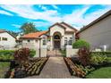 Grand home exterior with landscaped walkway and gated entrance at 11227 Macaw Ct, Windermere, FL 34786