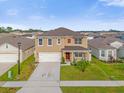 Two-story house with a two-car garage, front yard and driveway at 1139 August Sky Dr, Deltona, FL 32738
