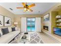 Living room with fireplace, sliding doors to pool, and comfortable seating at 8038 Glitter Ct, Orlando, FL 32836