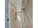 Bright and airy entryway with view into the living area and staircase at 4831 Saxon Dr # 2270, New Smyrna Beach, FL 32169