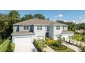 Three-unit townhouse building with gray siding and attached garages at 2650 Buena View Rd, Kissimmee, FL 34746