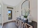 Bright and airy foyer with stylish console table and mirror at 5457 Hayloft Dr, Apopka, FL 32712