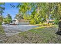 Spacious backyard with a detached garage and lush greenery at 1001 Tuscany Pl, Winter Park, FL 32789