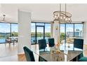Bright dining room with glass table and lake view at 322 E Central Blvd # 901, Orlando, FL 32801