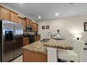 Modern kitchen with stainless steel appliances and granite countertops at 8947 Bismarck Palm Rd, Kissimmee, FL 34747